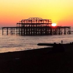 Pier on sea at sunset