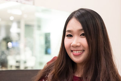 Close-up portrait of smiling young woman