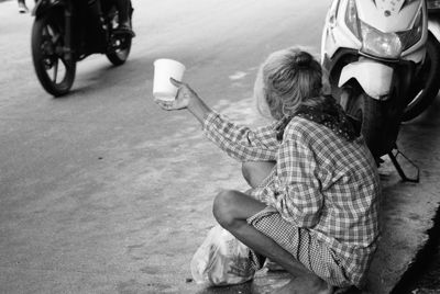 Boy sitting on the road