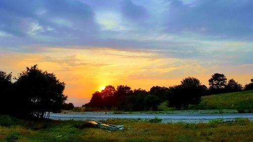 Scenic view of lake against sky during sunset