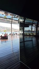 People in shopping mall against sky