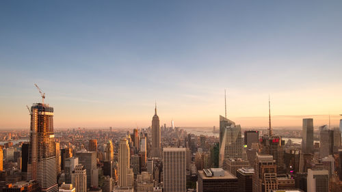 City buildings against sky during sunset