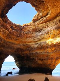 Rock formations in sea against sky