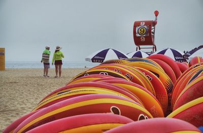 People standing by sea against sky