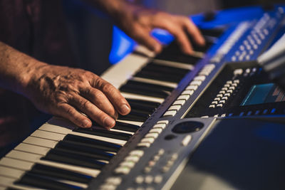 Midsection of man playing piano