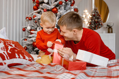 Boy playing with christmas presents