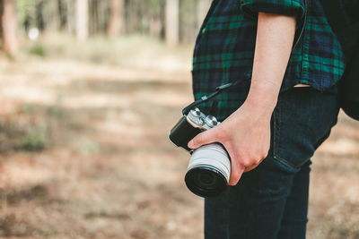 Midsection of man photographing camera