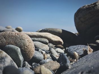 Pebbles on beach against sky