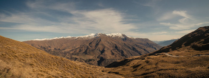 Scenic view of mountains against cloudy sky