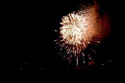 Low angle view of firework display at night