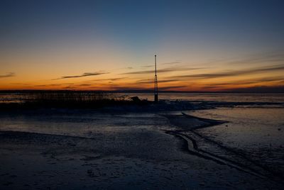 Scenic view of beach against sky during sunset