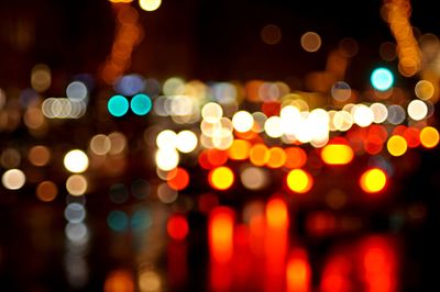 Defocused image of illuminated city at night