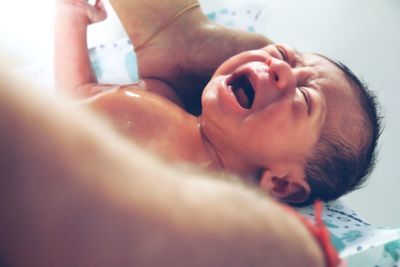 Close-up of crying baby boy at home