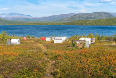 Fishermen's caravans by a lake deep in the swedish lapland. sunny day and fall colors in abisko np