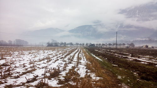 Snow covered landscape against sky