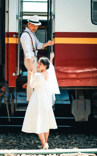 Rear view of couple standing on railway station