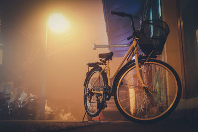 Bicycle on street in city against bright sun