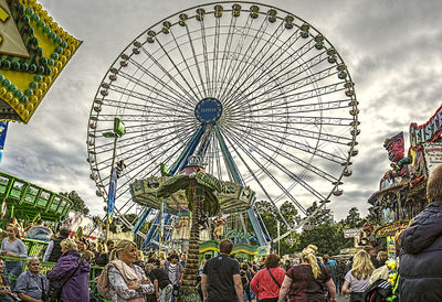 Low angle view of ferris wheel against sky