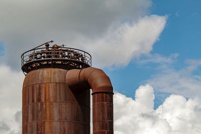 Low angle view of smoke stack against sky