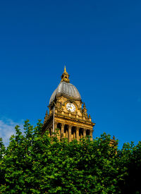 Low angle view of historic building against clear blue sky