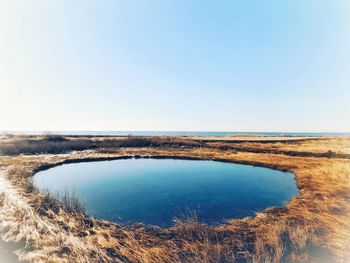 Scenic view of sea against clear blue sky