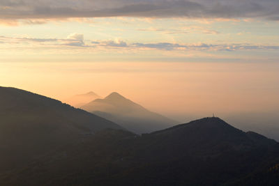 Scenic view of silhouette mountains against sky during sunset