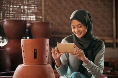 Portrait of young woman using mobile phone