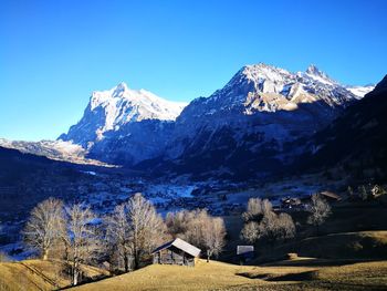 Low angle view of mountains against clear blue sky