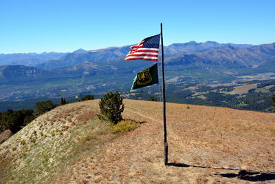 American flag waving at clay butte lookout against mountains