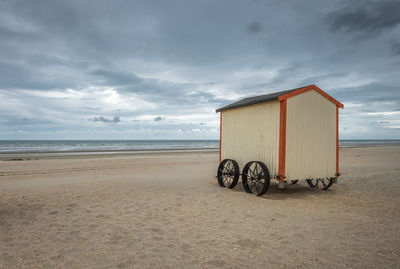 Bicycles on beach against sky