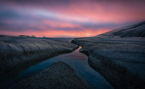 Scenic view of rock formation against sky during sunset