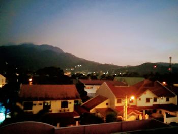 Houses in town against sky at night