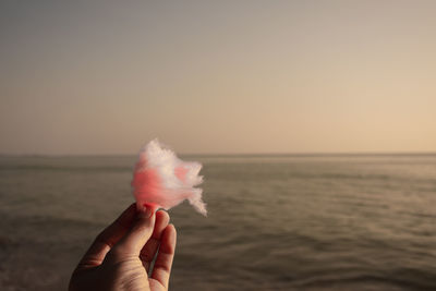 Holding cotton candy on the beach, mae ramphueng beach, rayong, thailand