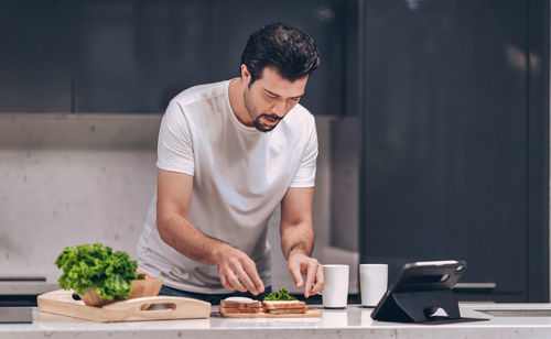 Young man preparing food on table