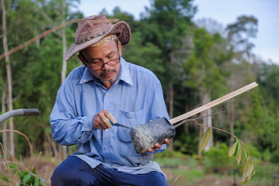 Portrait of man holding umbrella