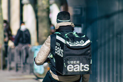 Rear view of man standing in city