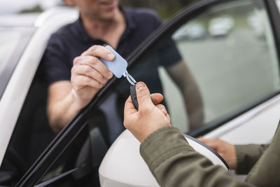 Customers trying car in car dealership