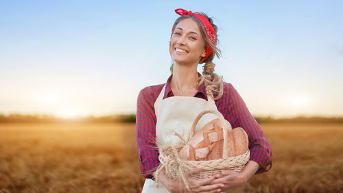 Portrait of a smiling young man standing in field