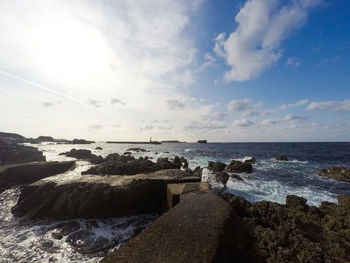 View of calm beach against the sky