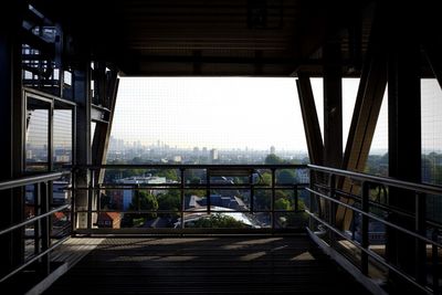 Cityscape against sky seen through bridge