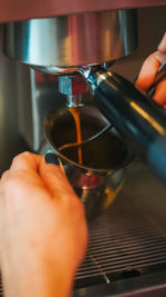 Close-up of hand holding coffee cup