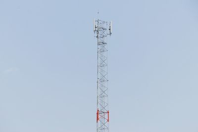 Low angle view of electricity pylon against clear sky