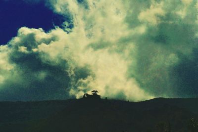 Low angle view of silhouette mountain against sky