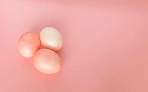 High angle view of eggs against pink background