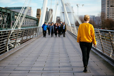 Full length of people walking in city