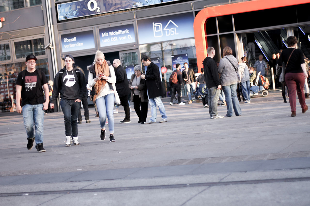 PEOPLE LOOKING AT CITY STREET