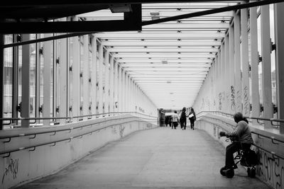 Rear view of people walking on footpath