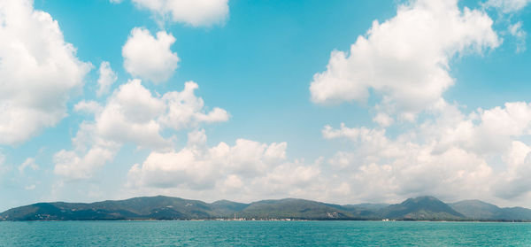 Panoramic view of sea and mountains against sky