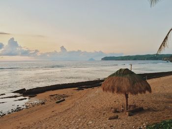 Scenic view of beach against sky during sunset