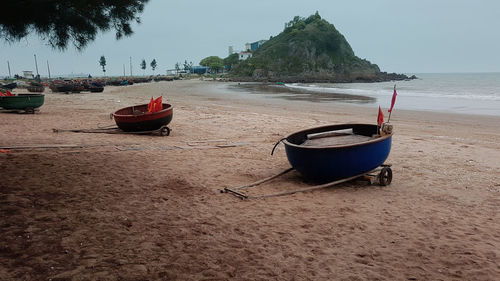 View of boats on beach against sky